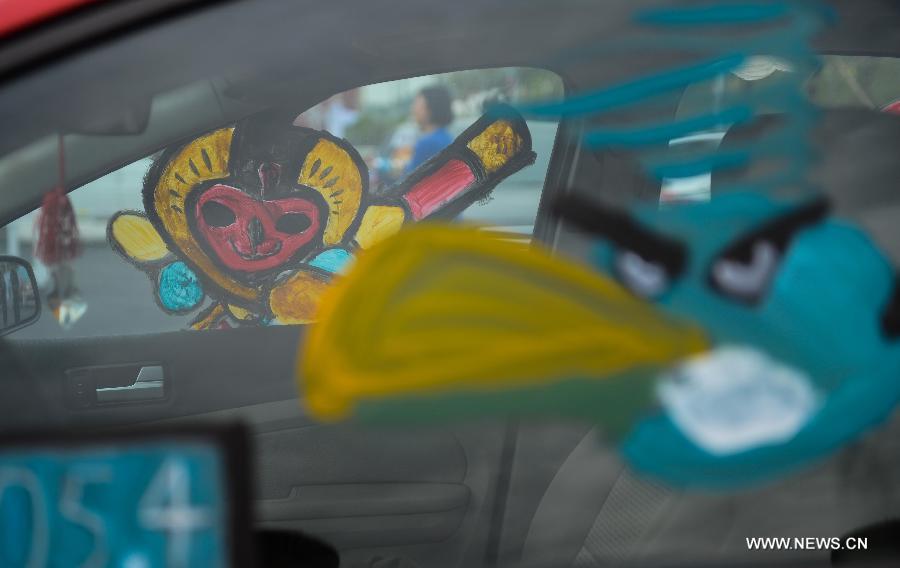 Cars with colorful cartoon drawings parade in Hangzhou