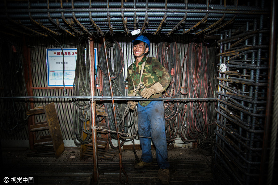 Workers behind Beijing's tallest building