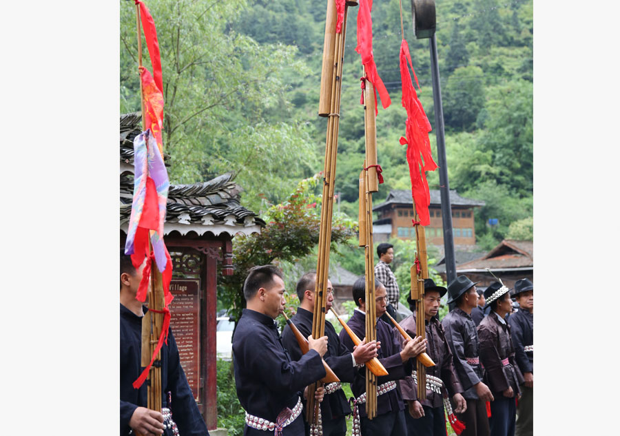 Miao people in traditional costume welcome experts in rural construction