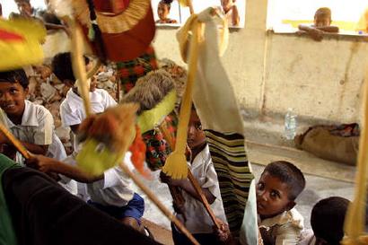 Young Sri Lankan tsunami survivors play with puppets at the Akurala Primary College relief camp in Galle in southern Sri Lanka, February 24, 2005. REUTERS/Anuruddha Lokuhapuarachchi 