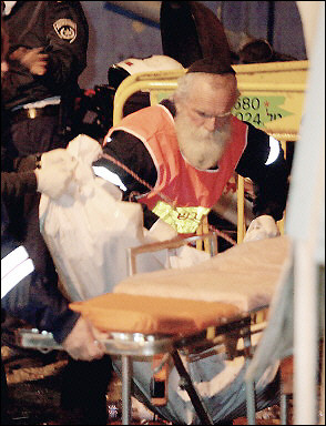 A body is evacuated from the scene of a suicide attack in Tel Aviv. Israeli officials briefed EU ambassadors on their allegations of a Syrian hand in a deadly Tel Aviv suicide bombing, as they stepped up their campaign to blacklist Lebanon's Hezbollah militia.(AFP/File/Yoav Lemmer)