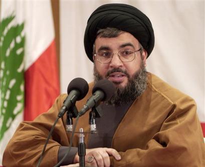 In front of the Lebanese flag. Sheik Hassan Nasrallah, leader of the Hezbollah gmovement, during a press conference in Beirut, Lebanon, Sunday March 6, 2005. Nasrallah, leading a group of pro-Syrian factions, called for a massive demonstration Tuesday to 'reject foreign intervention that runs contrary to freedom, sovereignty and independence, denounce the resolution-sedition 1559, to show thanks, loyalty and appreciation for Syria, leadership, people and army for its achievements in Lebanon.' [AP]