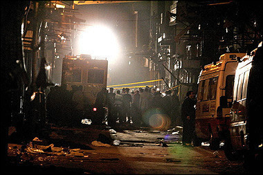 Egyptian police and interior ministry officials gather at the site of a bomb attack in a tourist area in the heart of Cairo. Two people, a French national and a US citizen were killed and 18 others wounded(AFP/Marwan Naamani)