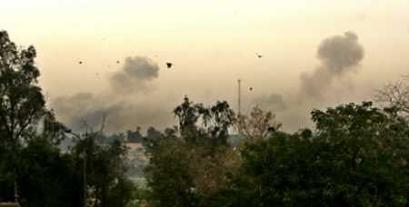 Two columns of smoke rise following a pair of loud explosions in Baghdad April 14, 2005. Two blasts shook Baghdad near the heavily fortified Green Zone on Thursday, and shooting broke out immediately afterwards. Smoke could be seen rising from the southwest part of Baghdad, near an entrance to the Zone, the headquarters of the Iraqi government and site of the U.S. Embassy. U.S. military spokesmen had no immediate information about the blasts. (Bob Strong/Reuters) 