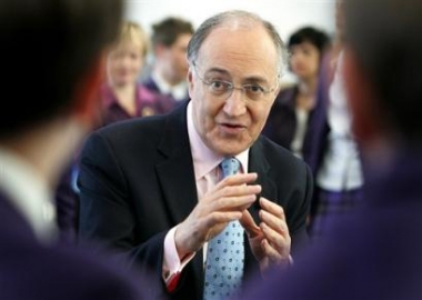 Britain's opposition Conservative leader Michael Howard, surrounded by children from the Oriel secondary school in Crawley, England smiles as he poses for the cameras, Thursday April 28, 2005. Britain goes to the polls in a general election on May 5, 2005. (AP