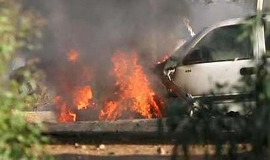 Iraq's government said on Thursday it would deploy 40,000 Iraqi troops in Baghdad in a massive crackdown on insurgents who have killed hundreds of people since the new cabinet was formed this month. An armored sport utility vehicle burns after being hit by a roadside bomb attack in Baghdad May 26, 2005. Photo by Stringer/Iraq/Reuters