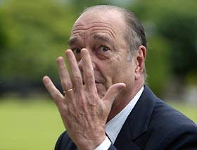 French President Jacques Chirac holds up his hand on arrival at Gleneagles Hotel for the G8 summit in Gleneagles, Scotland, July 6, 2005.