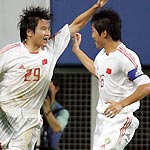 China's forward Li Jinyu (L) celebrates with team mate Ji Mingyi after scoring against Japan in the first half of their East Asian Football Championship match in Taejon, South Korea August 3, 2005. China tie 2-2 with Japan in the match. [Reuters] 