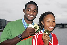 U.S. sprinters Justin Gatlin (L) and Allyson Felix (R) pose with the gold medals they won in competition at the World Athletics Championships in Helsinki August 14, 2005. 