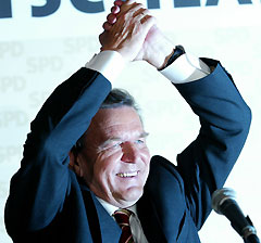 German Chancellor Gerhard Schroeder celebrates at the SPD party headquarters in Berlin September 18, 2005.