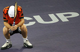 Guillermo Coria of Argentina reacts after missing a shot during a match against Roger Federer of Switzerland in the Tennis Masters Cup in Shanghai, China November 17, 2005. 