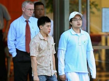 Khao Nguyen Tuong (R), brother of convicted Australian drug smuggler Nguyen Tuong Van, and lawyer Julian McMahon (L) leave Changi prison after Nguyen's execution in Singapore December 2, 2005.