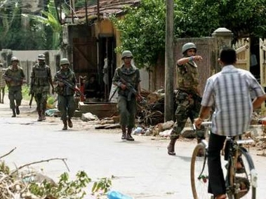 Sri Lankan government soldiers patrol a street in Jaffna, northern Sri Lanka, December 20, 2005.