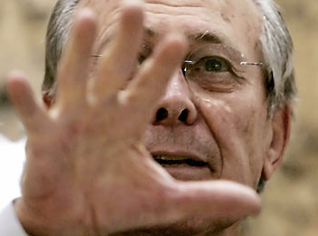 U.S. Secretary of Defense Donald Rumsfeld addresses soldiers during a Town Hall meeting in Fallujah, Iraq, December 23, 2005. Rumsfeld said on Friday the number of U.S. combat troops in Iraq would be cut by some 7,000 by early next year, but the number involved in training Iraq's new military would increase.