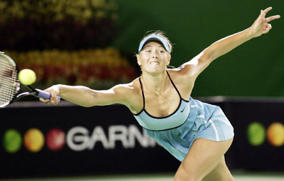 Maria Sharapova of Russia hits a return against Justine Henin-Hardenne of Belgium at the Australian Open tennis tournament in Melbourne January 26, 2006. 