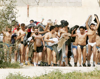 Palestinians taken as prisoners by the Israeli army walk out of the jail during an Israeli army raid on the jail in Jericho 