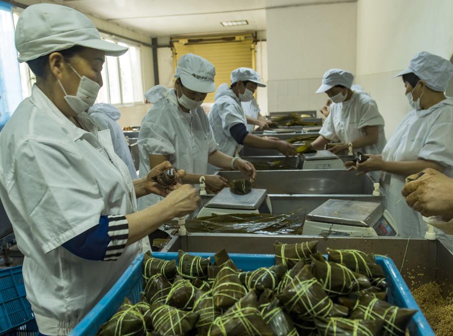 Workers in Central China make zongzi before Dragon Boat Festival