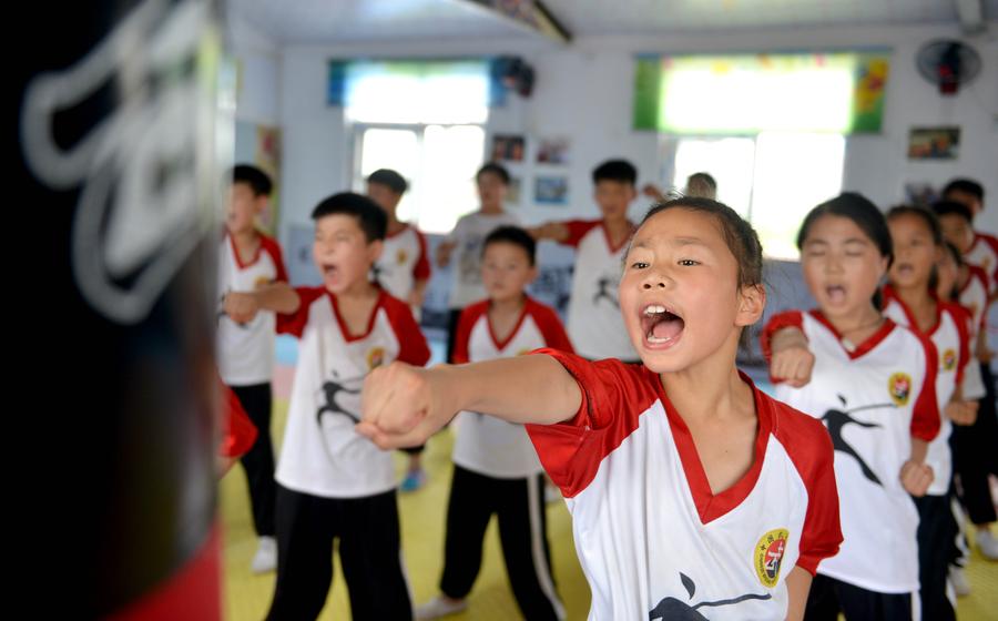 Children learn martial arts at training center in Henan province