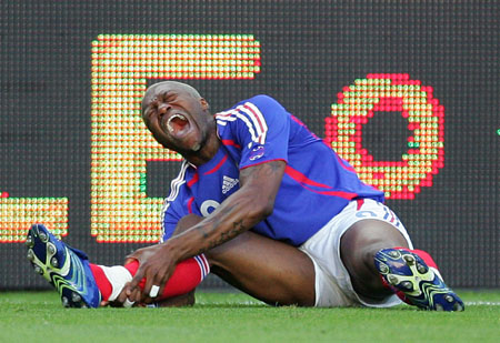 Djibril Cisse of France cries out in pain after being tackled by China's Zheng Zhi during a friendly international soccer match at the Geoffroy-Guichard stadium in Saint Etienne, France June 7, 2006.