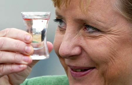 German Chancellor Angela Merkel toasts during the laying of the foundation stone in Grevenbroich, near the western city of Duesseldorf August 23, 2006. 