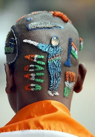 True fan : Indian cricket fan, Bhola Sarder, poses after the daily shaving of his 'Cricket World Cup' haircut at a hair salon in Howrah, near Kolkata.(